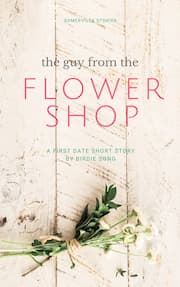 A bundle of cut flowers tied with string, resting on a wooden surface. The Guy from the Flower Shop by Birdie Song.